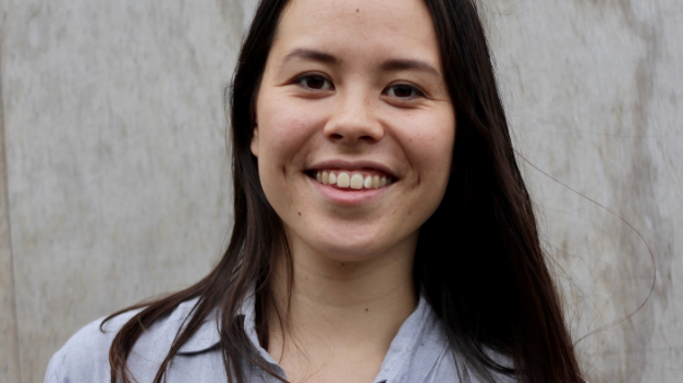 Portrait of Lili, founder of Vaer Upcycled, smiling in a light shirt.
