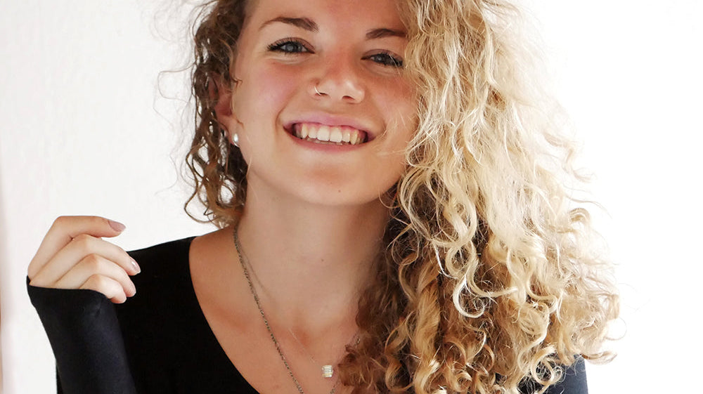 Portrait of textile engineer and author Franzi Uhl smiling in a black top.
