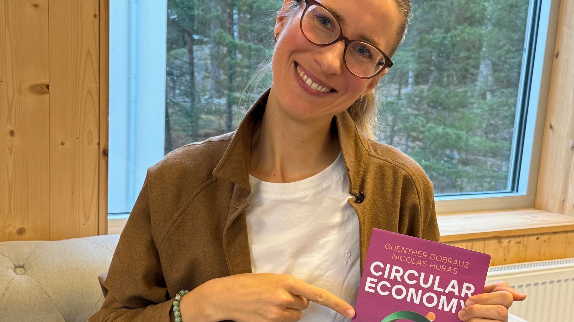 Franziska Mesche pointing at the Circular Economy book featuring her contribution.