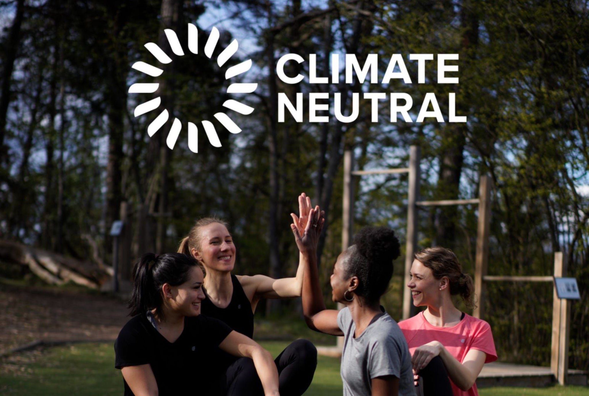 Women training outdoors with a Climate Neutral logo overlay.