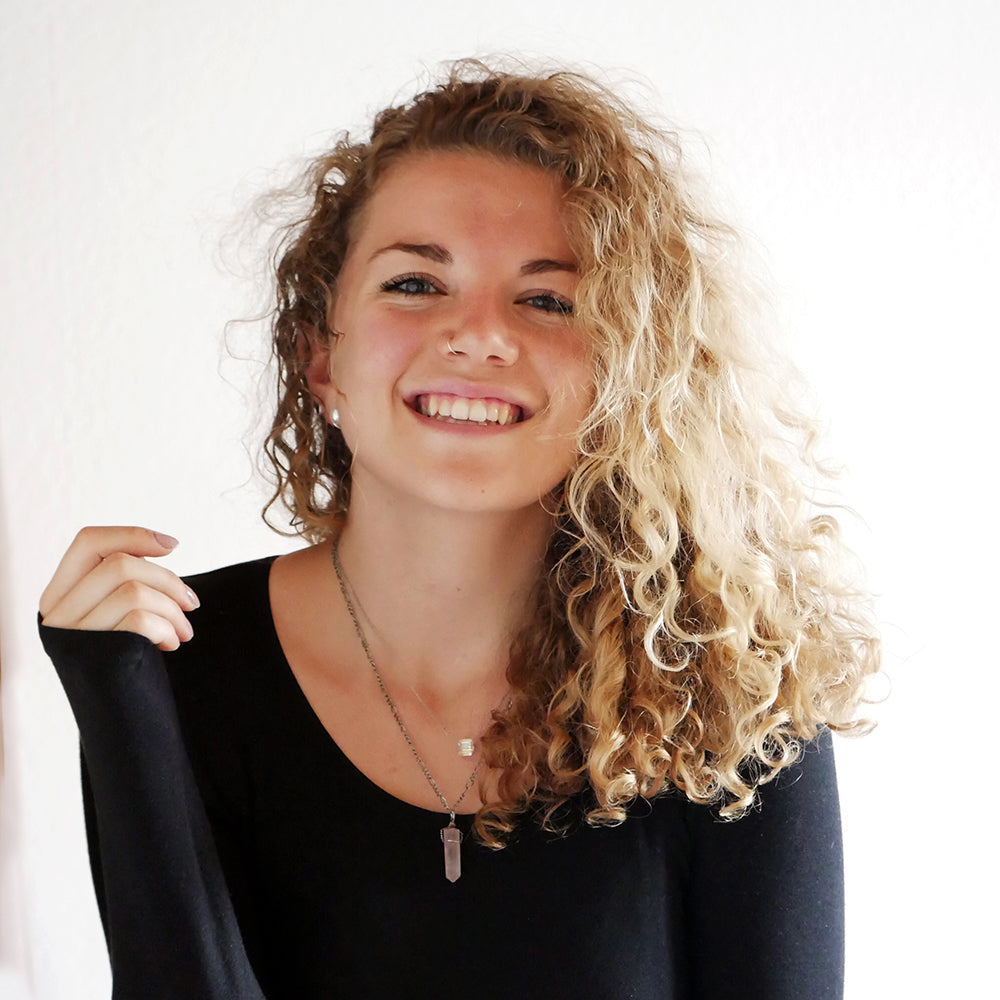 Portrait of textile engineer and author Franzi Uhl smiling in a black top.